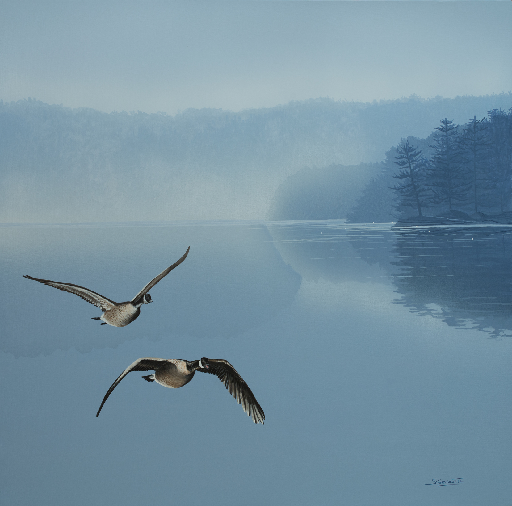 two Canada geese fly towards you with blue and deep blue lake scene in background